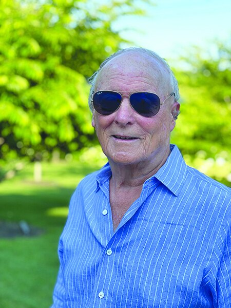 Author George Karp outdoors in sunglasses and a blue shirt