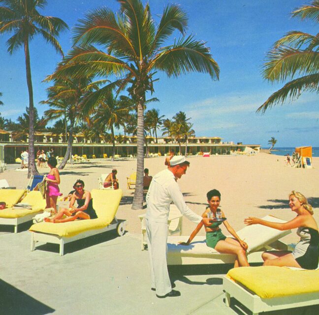 Sunbathers and palm trees at a mid-century Boca Raton beach club