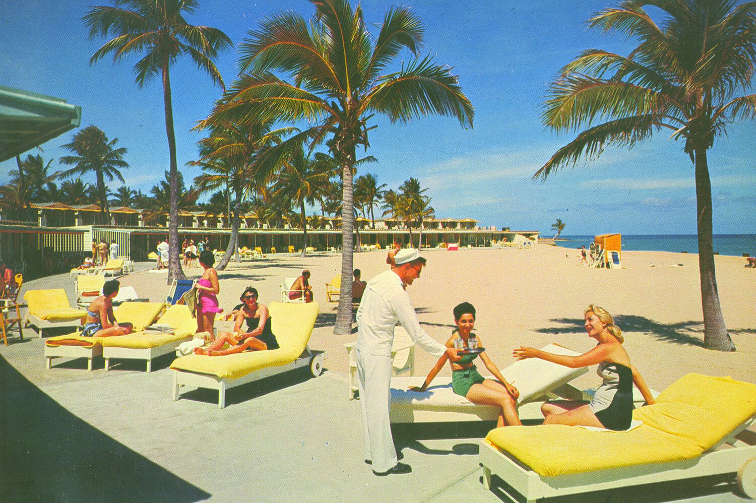 Sunbathers and palm trees at a mid-century Boca Raton beach club