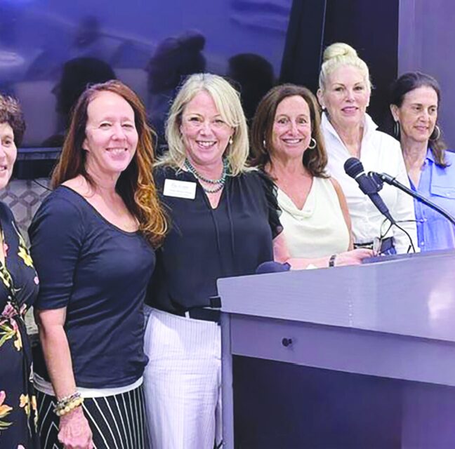 Boca Pointe Pap Corps members with CEO Sally Berenzweig at the installation podium