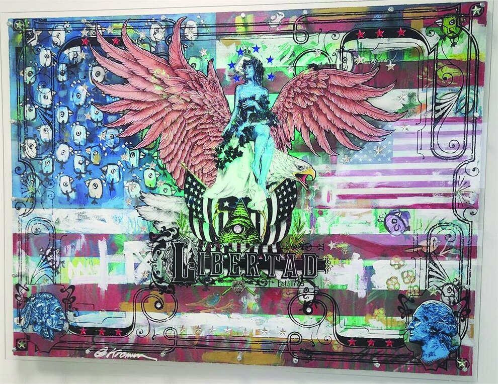 Libertad mixed-media artwork over an American flag backdrop in a lobby
