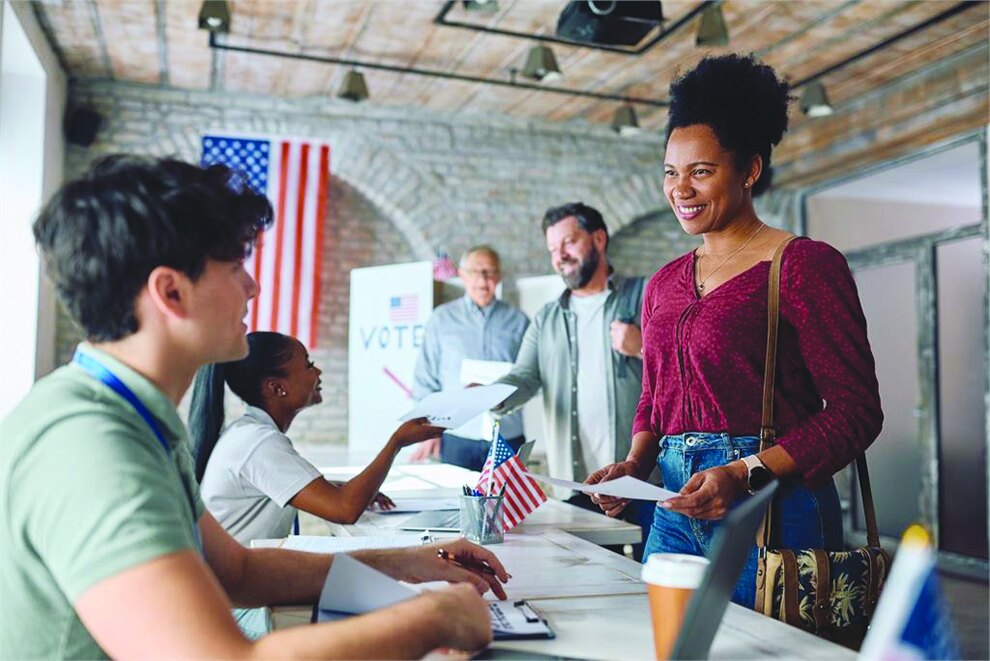 Voters checking in with poll workers at a polling place