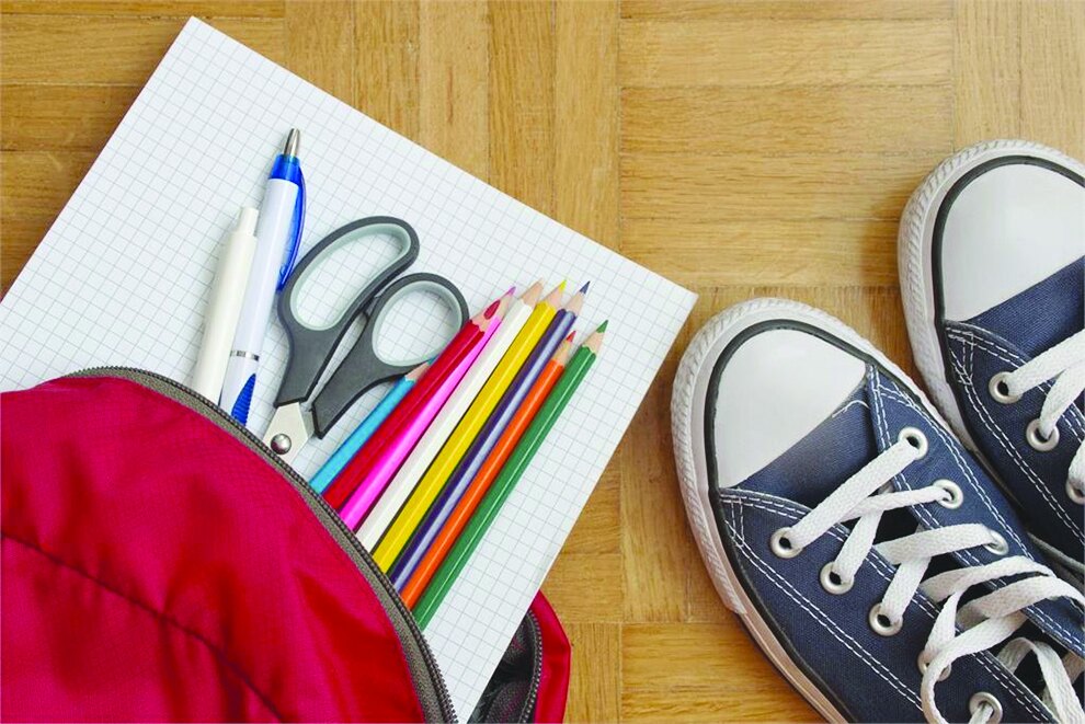 School supplies, backpack and sneakers laid out for back-to-school shopping