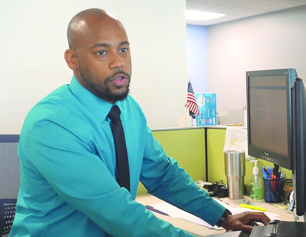 Tax Collector office employee working at a service center workstation