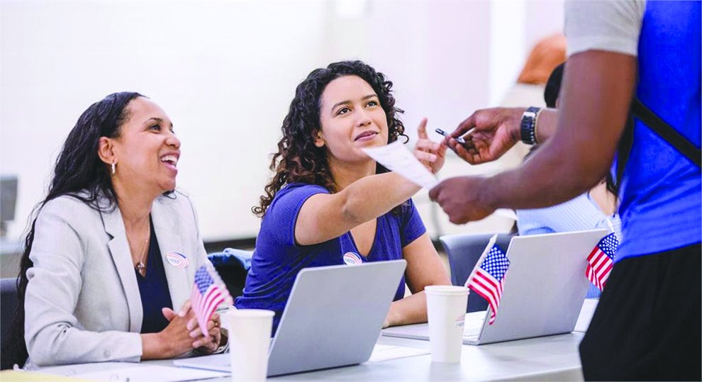 Tax Collector staff helping a customer at a service counter